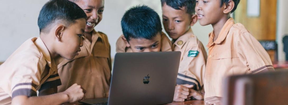 Boy Using Silver Macbook for viewing