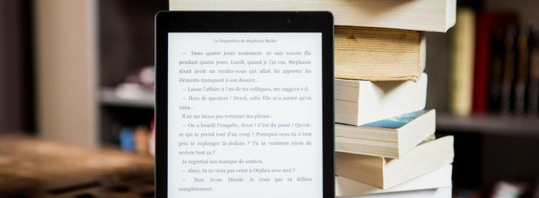 a tablet leaning on a stock of books