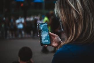 A woman checking of her phone and sharing information through chat