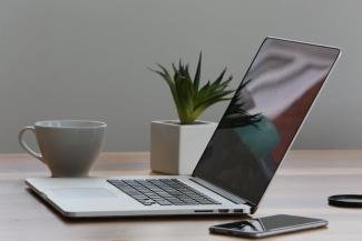 gray laptop in an organize table