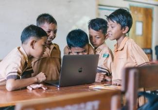 Boy Using Silver Macbook for viewing